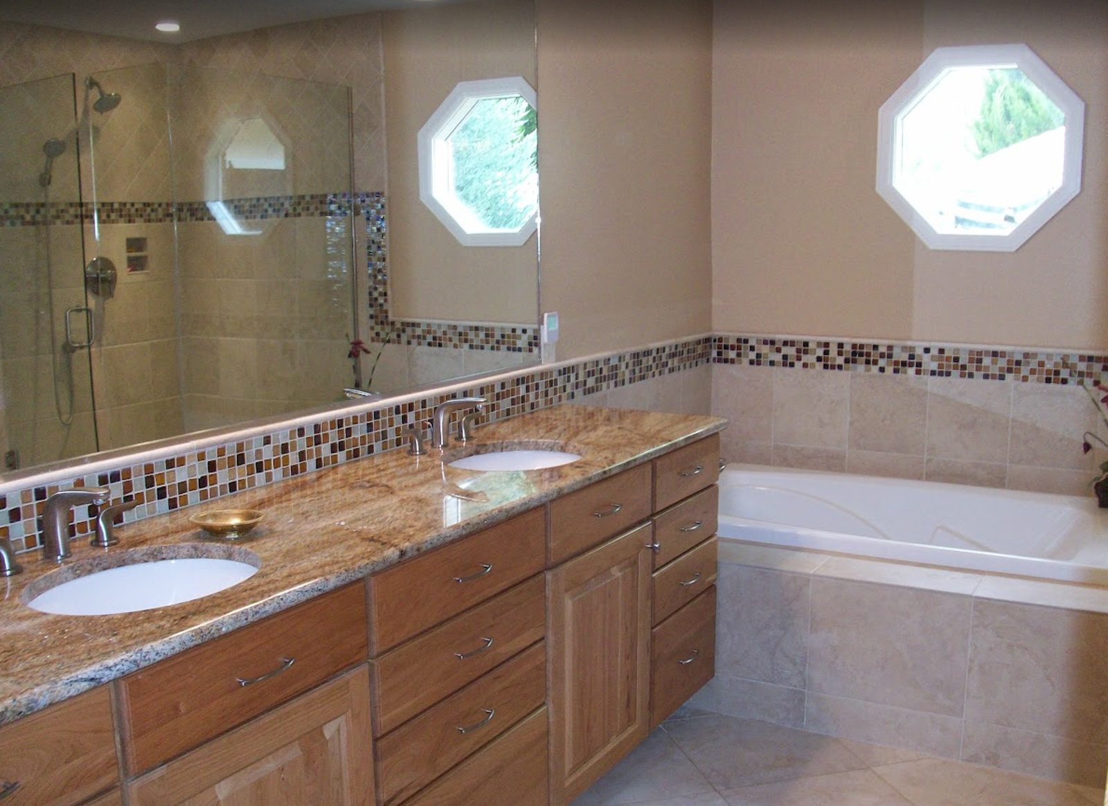Remodeled bathroom with custom tub surround and tile by Prana Construction