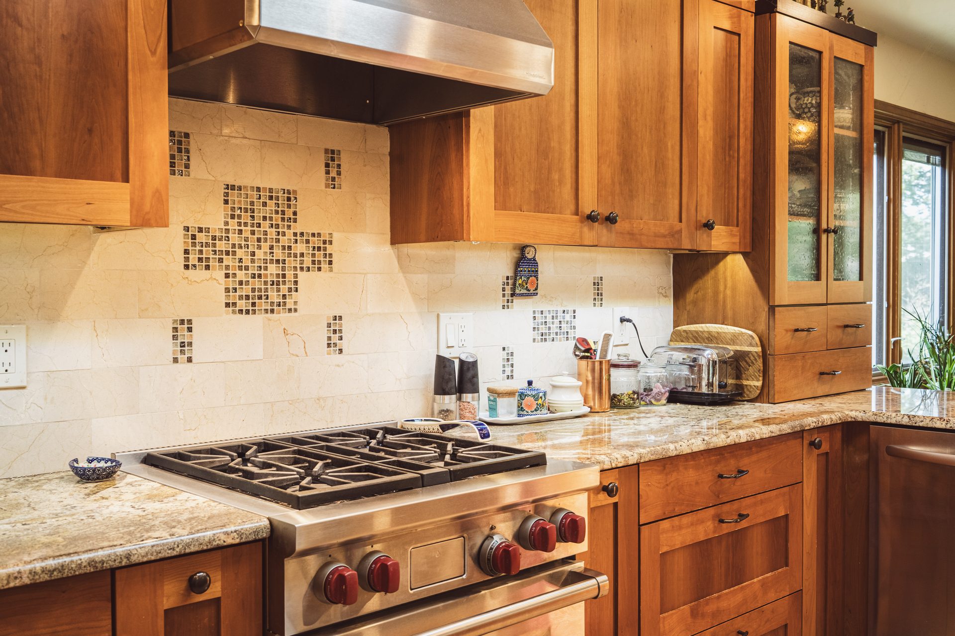 Traditional kitchen remodel with cherry cabinetry, granite countertops, and professional gas range